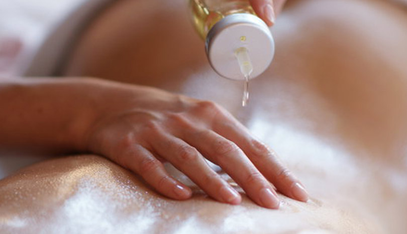 masseuse is applying oil to your partner
